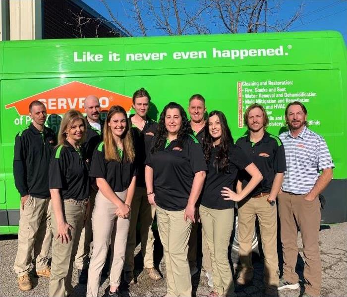 Group picture of SERVPRO employees standing outside in front of SERVPRO van