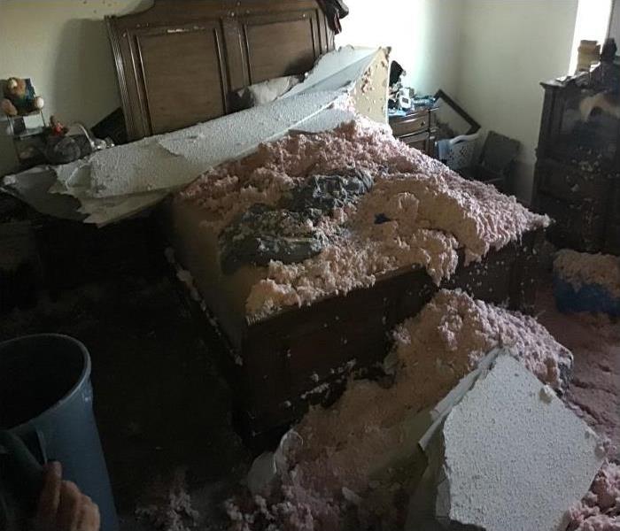 Mass amounts of insulation and ceiling drywall plummet onto bed after attic water loss