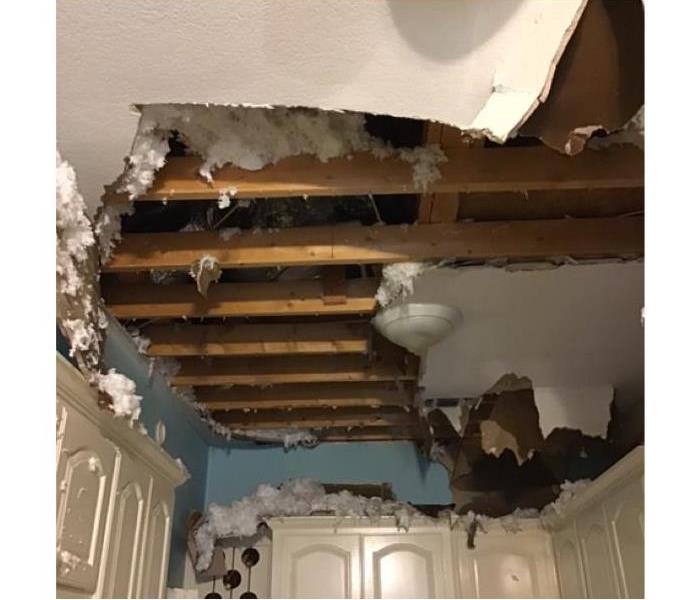 Ceiling drywall and insulation completely collapsed due to water loss.