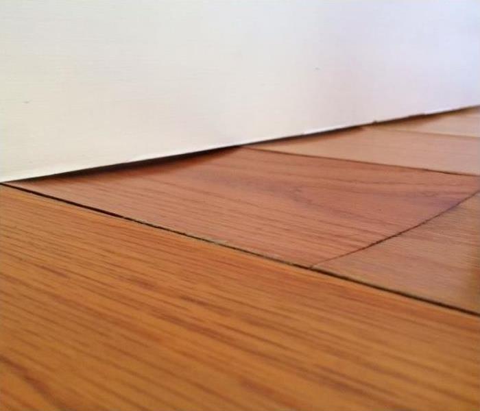 Up-close image of warped wood flooring
